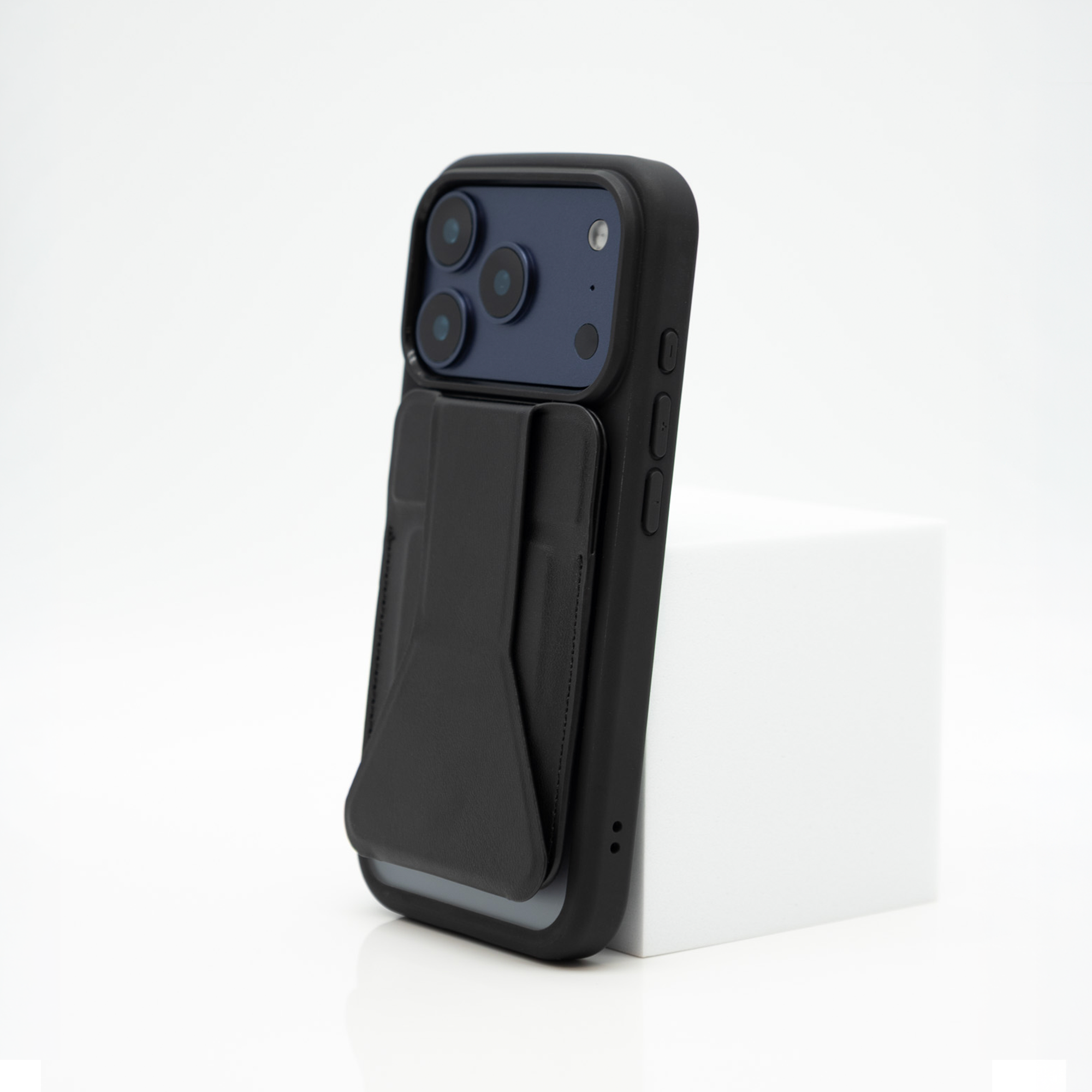 Black Peel Magnetic Wallet Stand attached flat to the back of an iPhone, shown from the rear