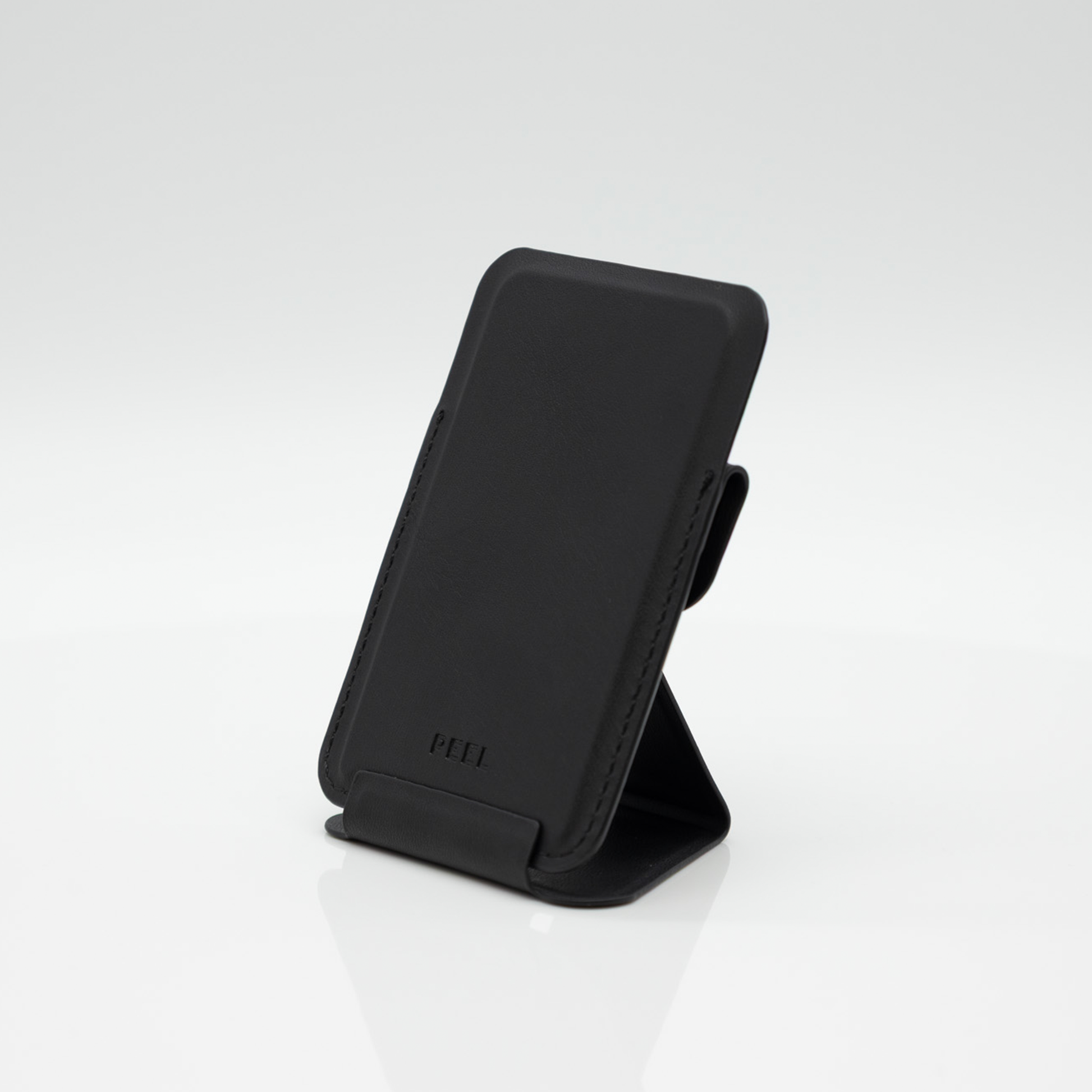 Peel Magnetic Wallet Stand standing upright with the fold-out stand extended