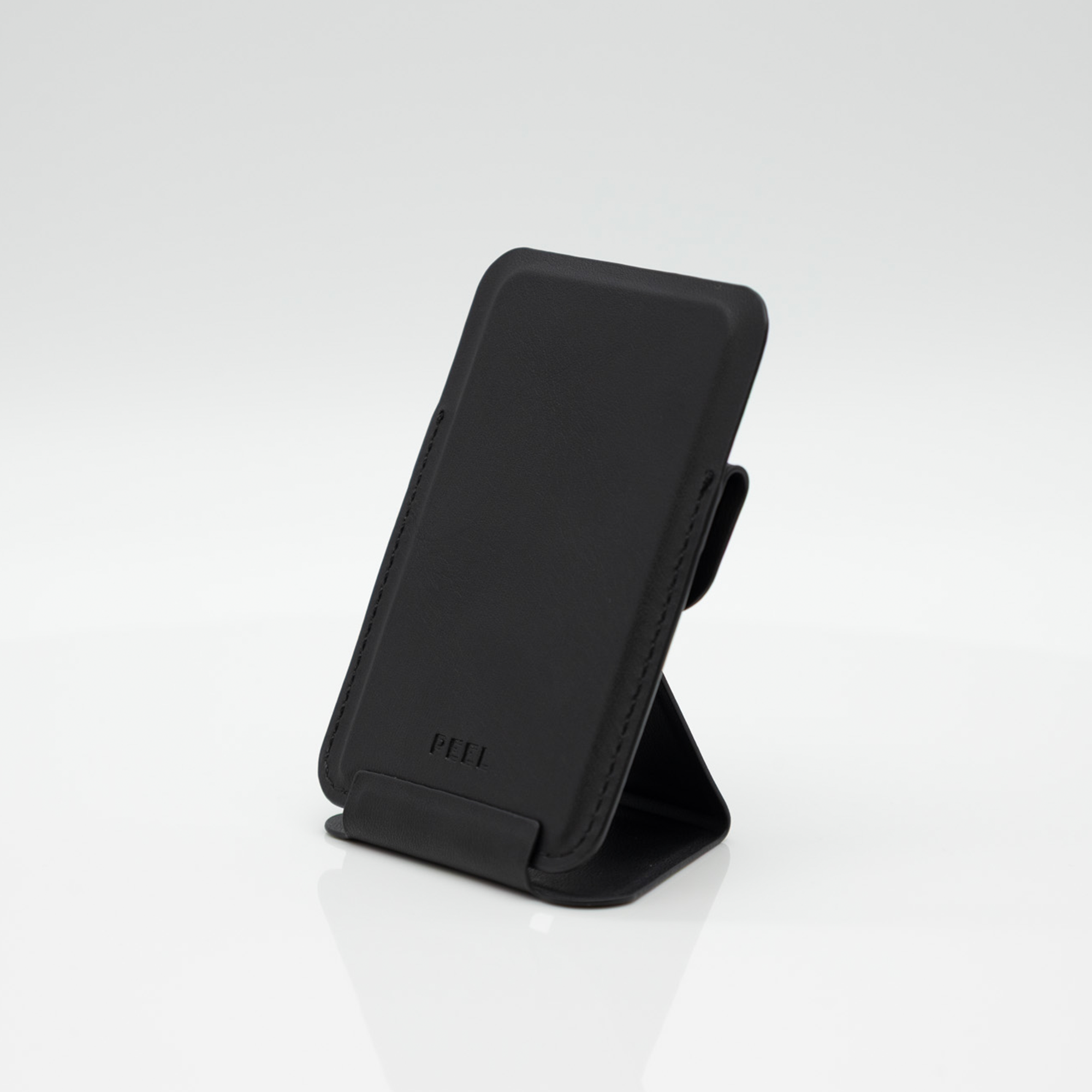 Peel Magnetic Wallet Stand standing upright with the fold-out stand extended