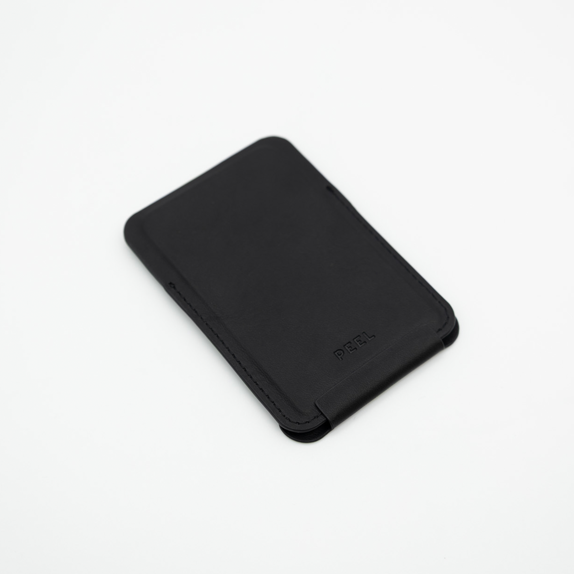 Black Peel Magnetic Wallet Stand lying flat with the stand folded closed, showing its slim profile