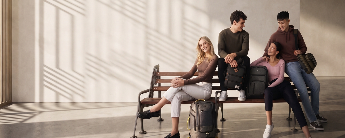 Four people carrying Solo New York backpacks and briefcases