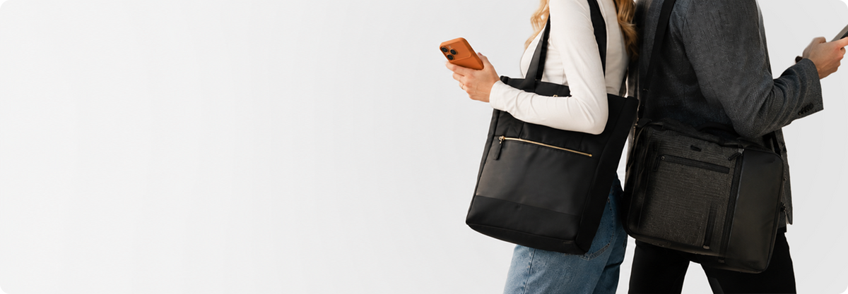 Two people walking with Solo New York bags over the shoulder
